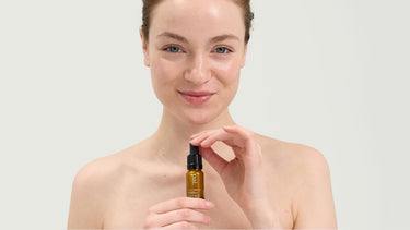 Woman holding Pai Skincare Tri-Mushroom Super-Soothing Booster